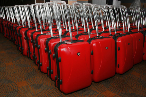 Rows of red rolling suitcases lined up for the Allure Best of Beauty party in 2006.